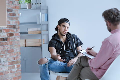teen boy talking with therapist